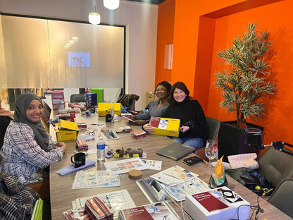 Group of people sitting around a table VeinTrain flat-pack vein simulator for phlebotomy and cannulation training
